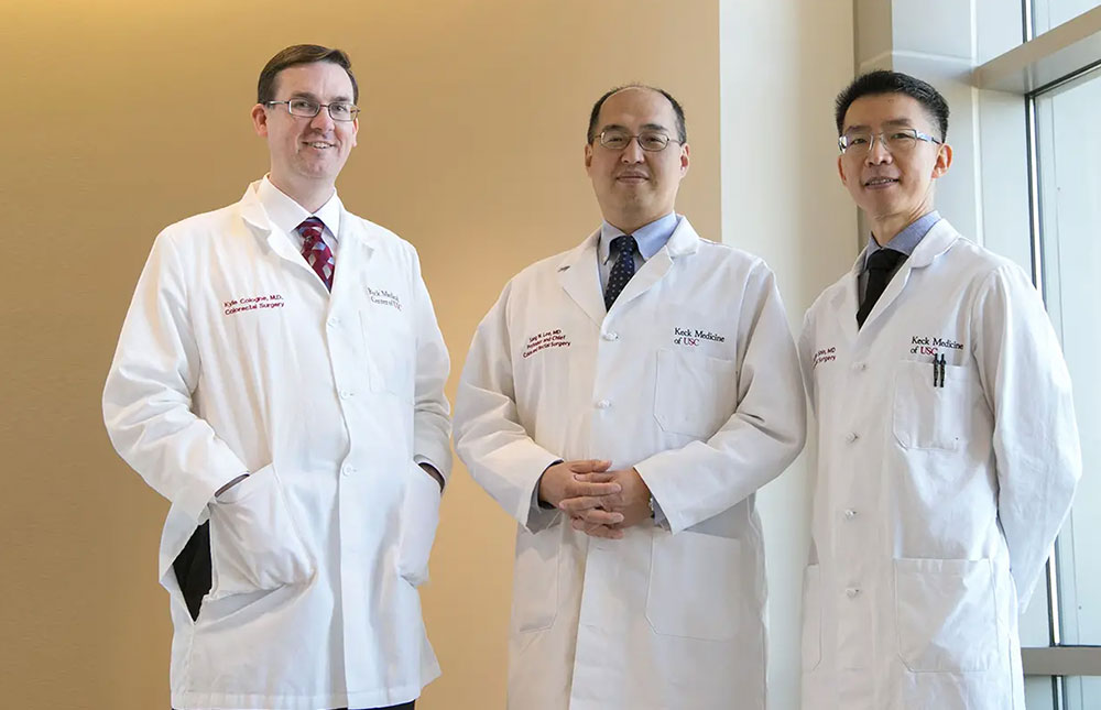 Three colorectal surgeons stand side by side.