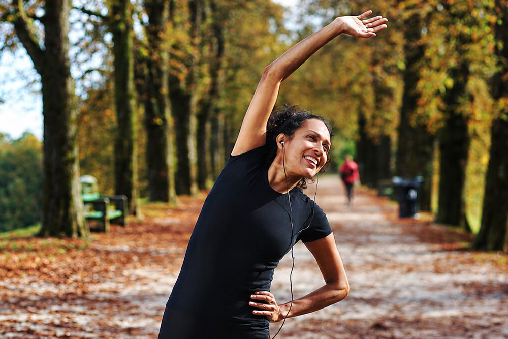 Stretching beneath autumn trees