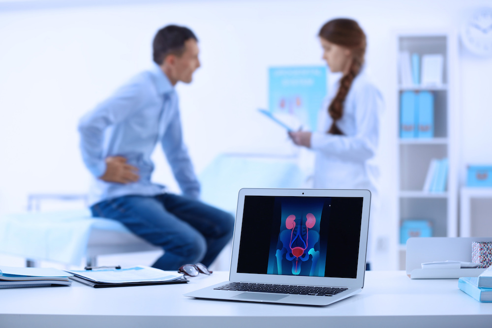 https://www.keckmedicine.org/wp-content/uploads/2021/11/A-laptop-displays-an-image-of-the-urinary-system-while-a-man-holds-his-side-as-he-speaks-to-a-urologist-in-a-clinical-exam-room..jpg