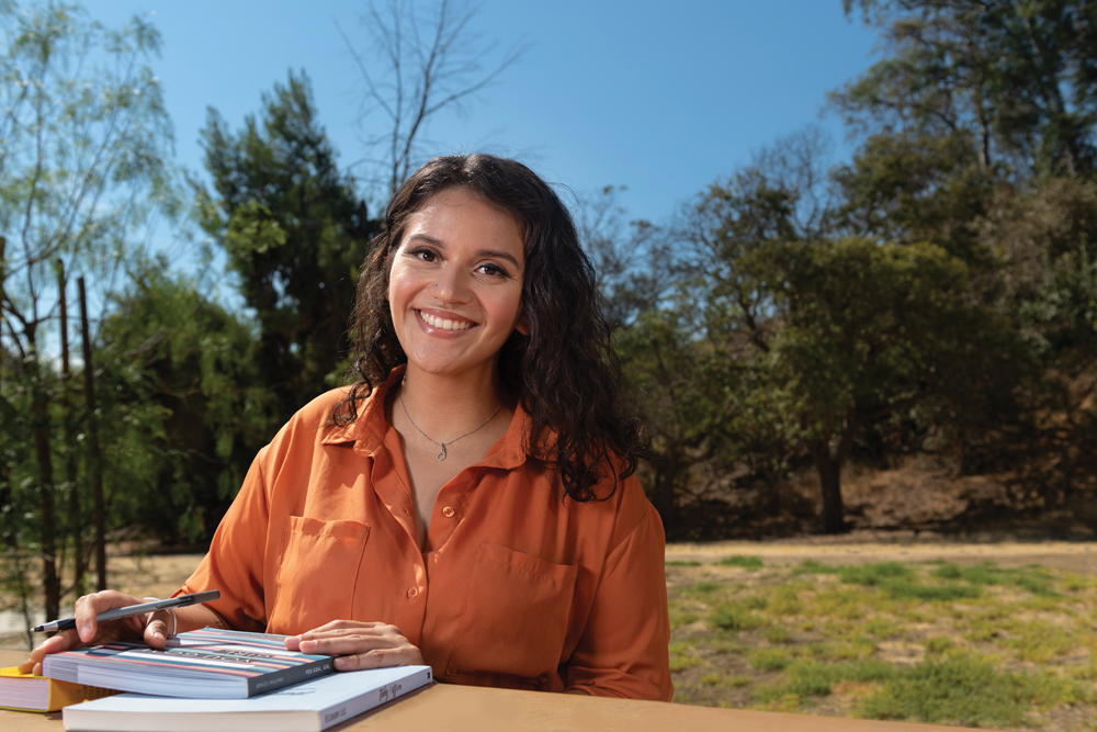 Bariatric surgery patient Brianna Villanueva sits at a table outdoors