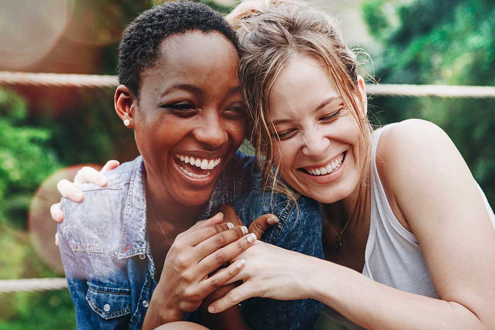 cheerful girls embracing each other