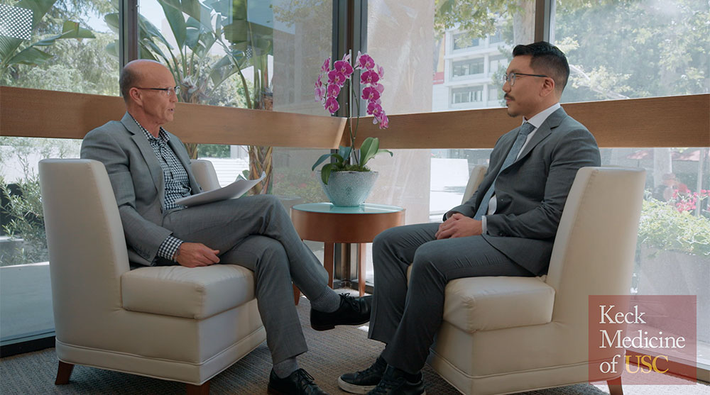 two men, Rod Hanners and Raymond Hah, sit across from each other in an office building