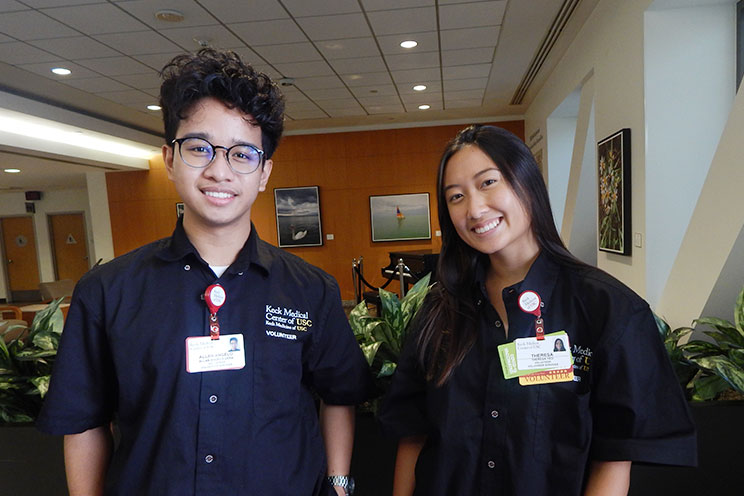 Keck Medical Center of USC youth volunteers greeting patients in the lobby