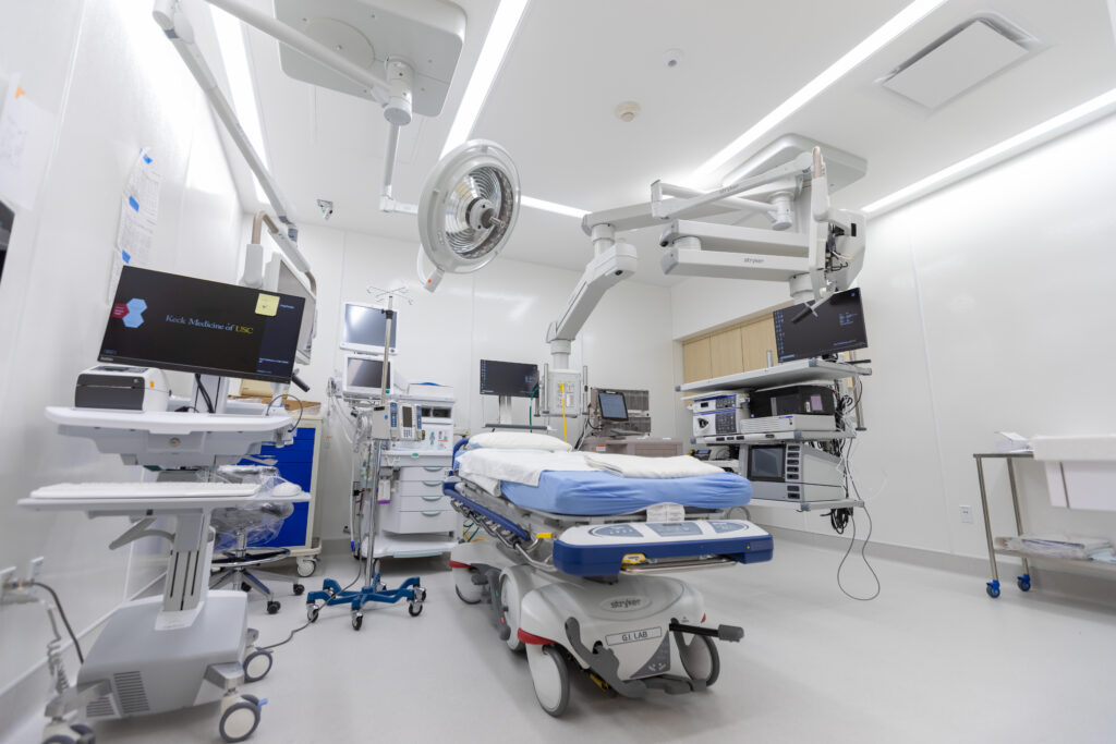 A room at the advanced endoscopy laboratory at Keck Medical Center of USC, including a patient bed, several imaging systems and several imaging screens 