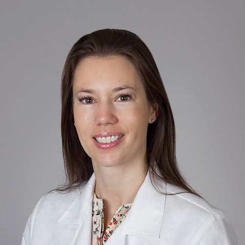 A portrait photograph of USC Family Medicine primary care physician Jennifer Boozer in a white lab coat 