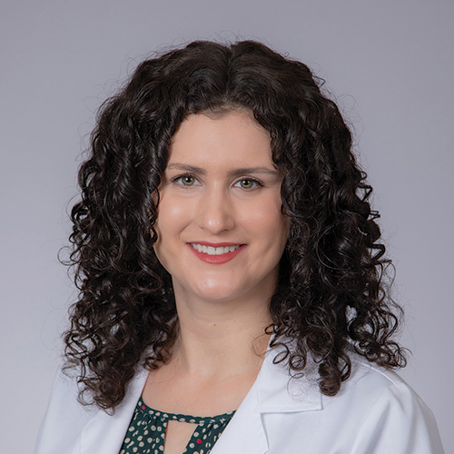 A portrait photograph of USC Metabolic and Bariatric Surgery Program's bariatric program manager Allison Larraga in a white lab coat 