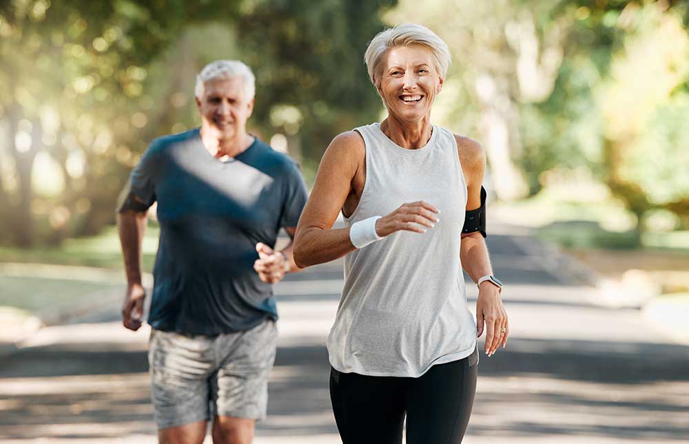 A woman and a man jogging together in a park