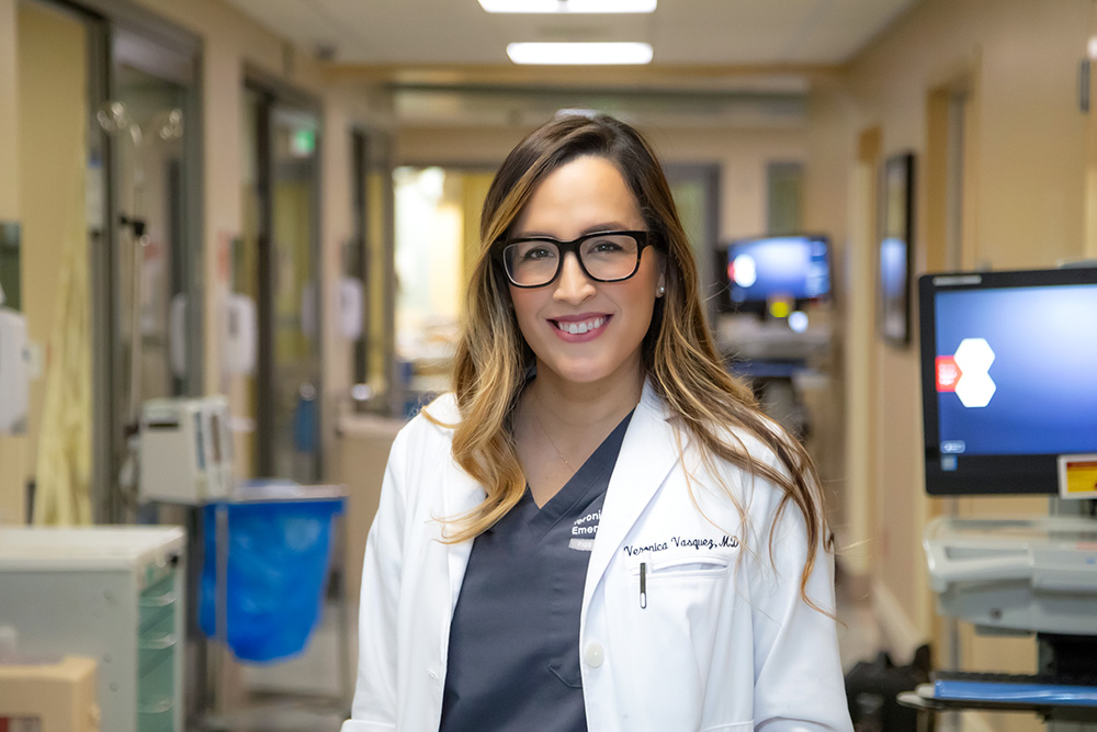 Veronica Vasquez-Montez, MD, smiles in the hallway of USC Arcadia Hospital's emergency department