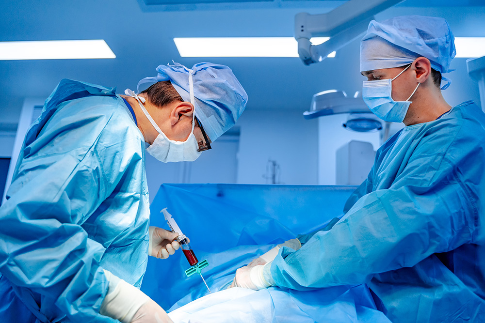 Doctors treat a bone marrow transplant patient in the OR.