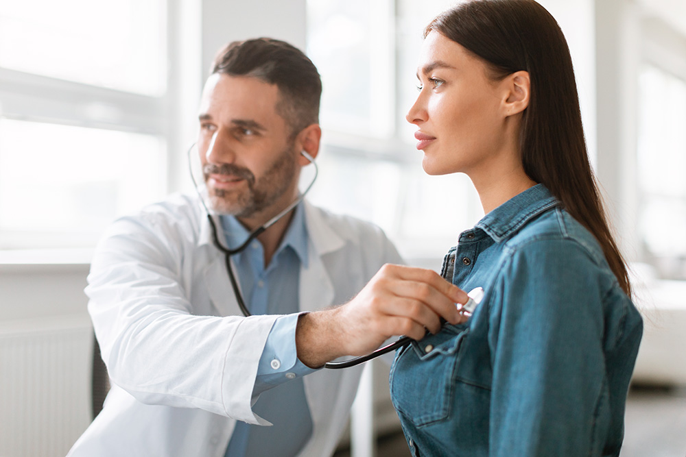 A heart transplant patient attends a follow-up visit to make sure her new heart will last.