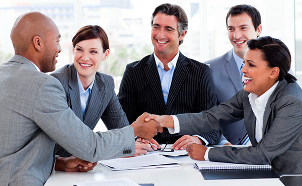 Professional healthcare support staff smiling and sitting together as a team.