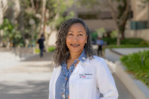 Dr. Nicole Greene stands outside and smiles.