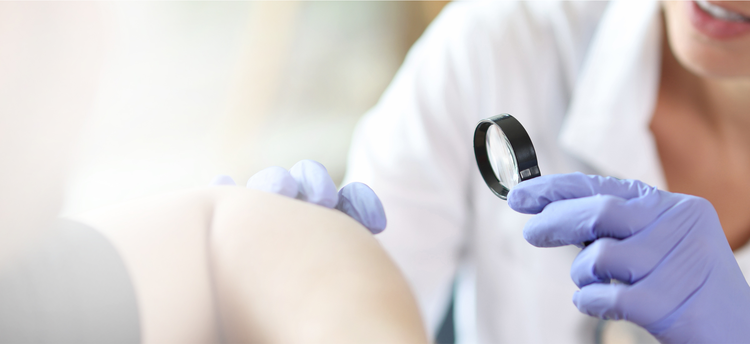 A dermatologist examines skin for contact dermatitis.