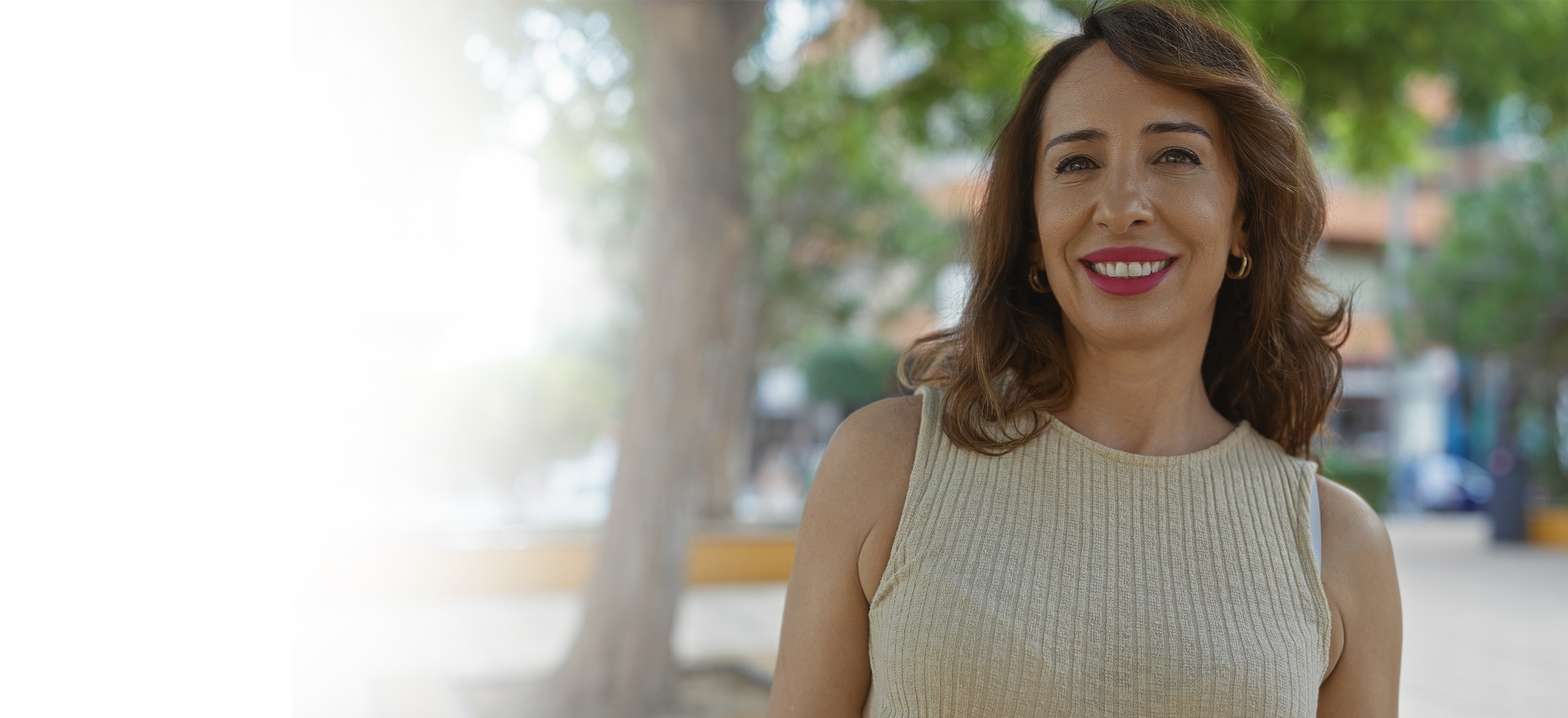 A woman smiles after receiving weight management care.